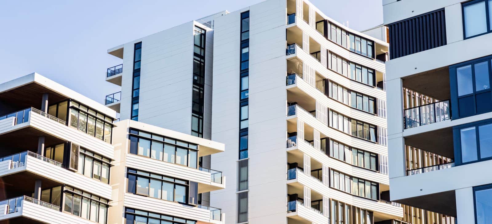 Apartment Buildings With White Facade And Balconies
