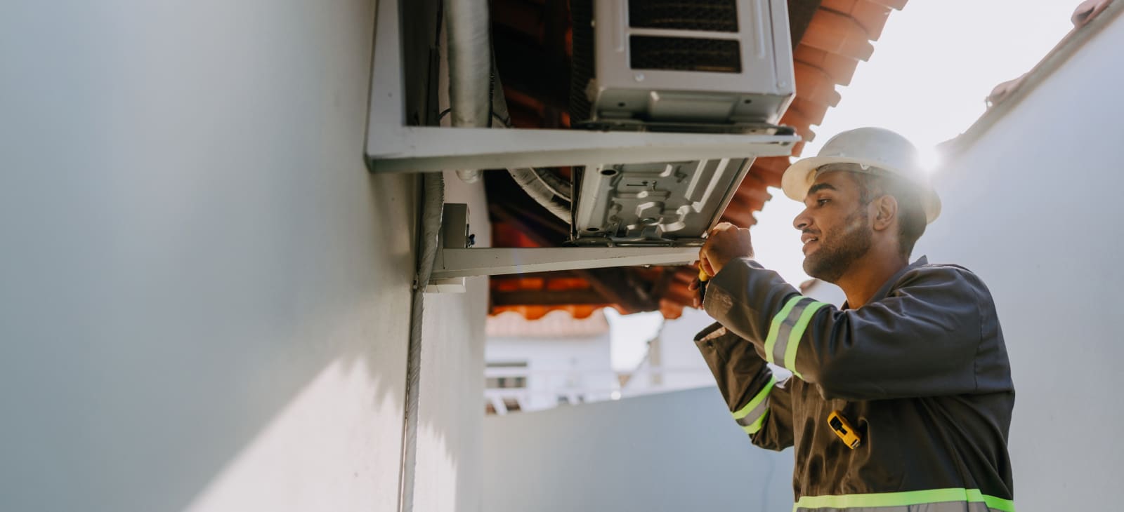 Hvac Technician Inspecting Rooftop Air Conditioning Unit