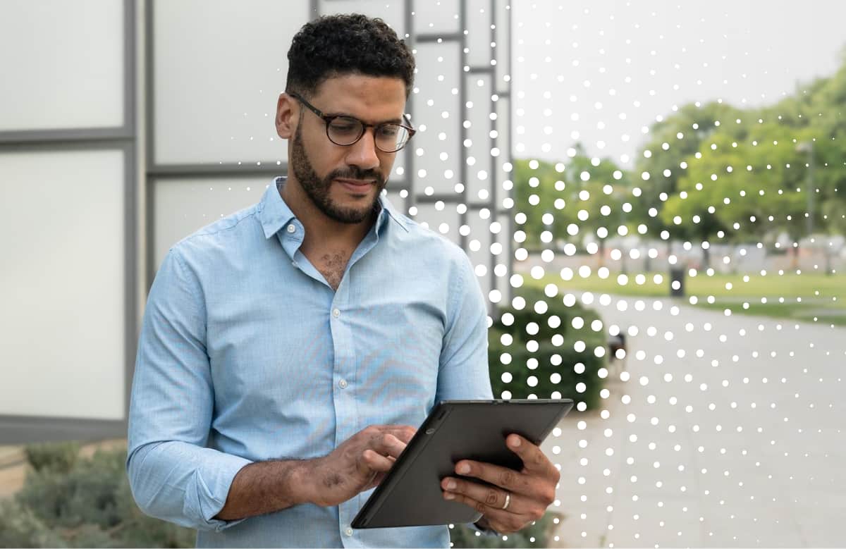 Man In Glasses Holding Tablet Outdoors By Modern Building