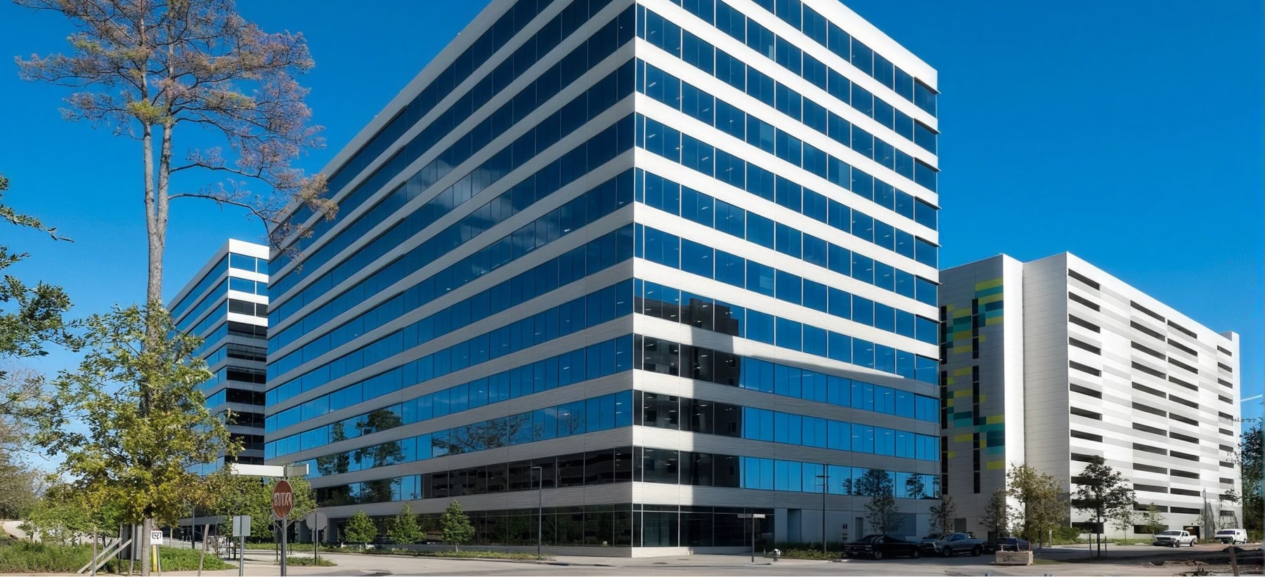 Modern Office Building With Blue Glass Facade And White Horizontal Bands