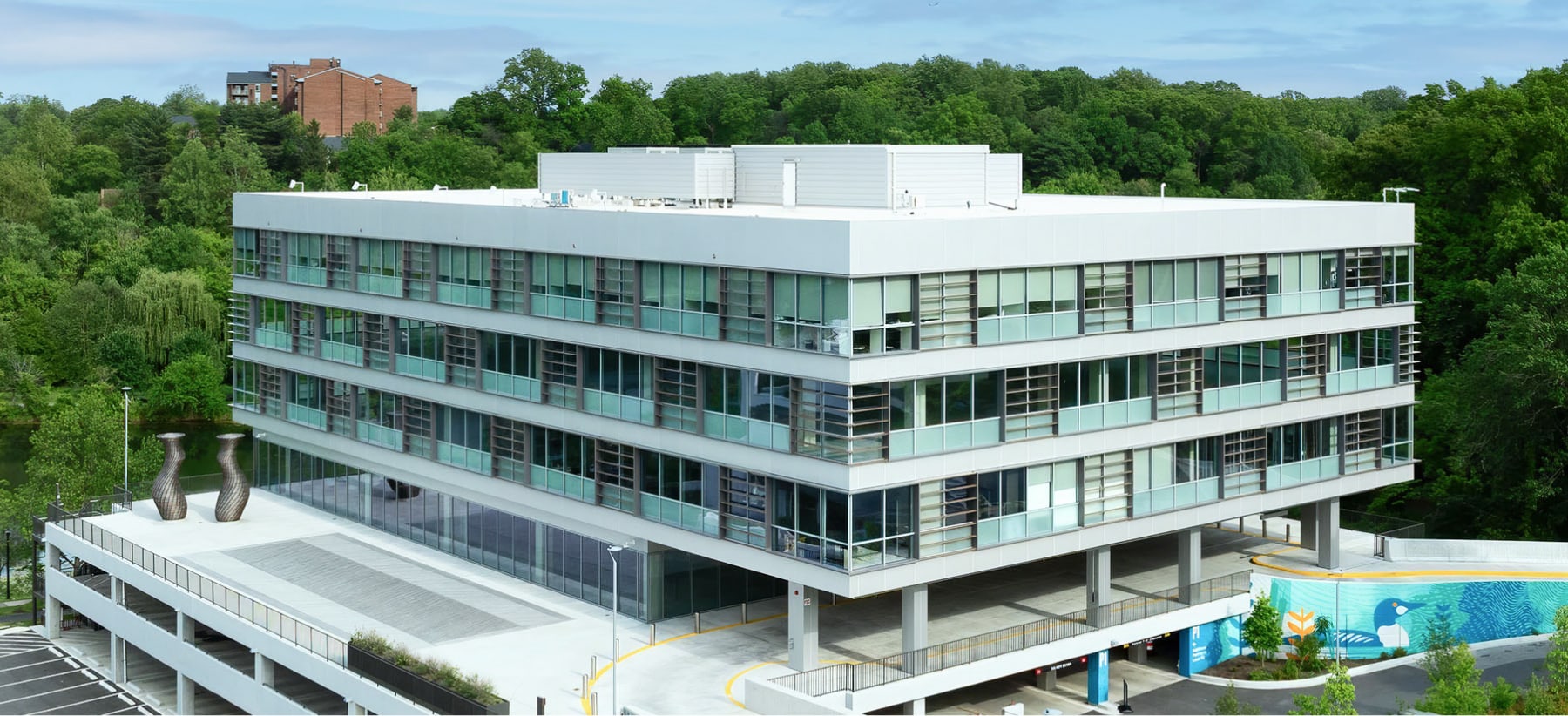 Modern Office Building With Green And Blue Vertical Louvers Glass Facade Hero