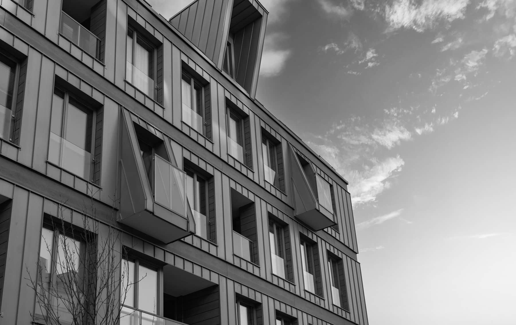 Modern Residential Building Facade With Metal Balconies And Windows