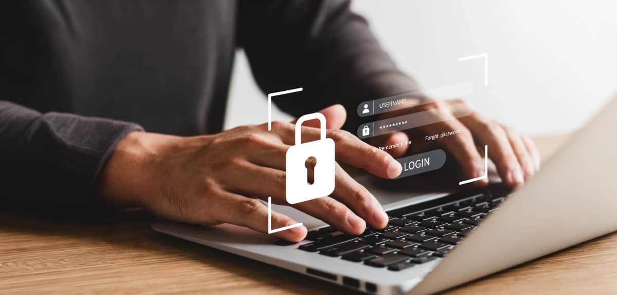 Person Entering Login Credentials On Laptop With Security Lock Icon
