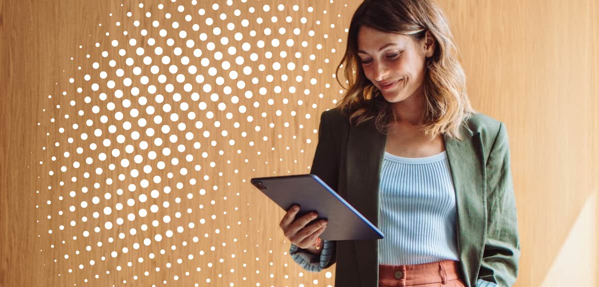 Woman Holding Tablet Looking Down In Modern Office Space